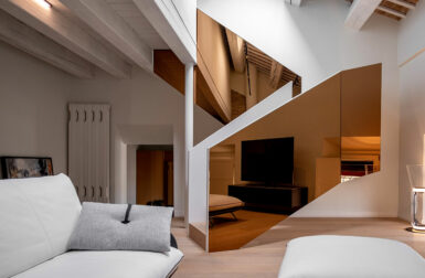 An Italian Penthouse Shines With Colored Mirrors in Forlì